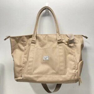 Herschel women's handbag in plain brown canvas with zipper closure.